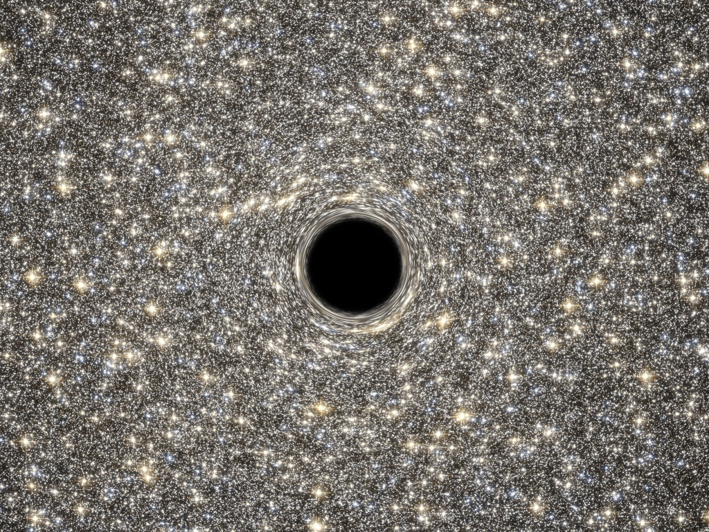 An image of a supermassive black hole with countless silver and gold galaxies spiraling out around it.